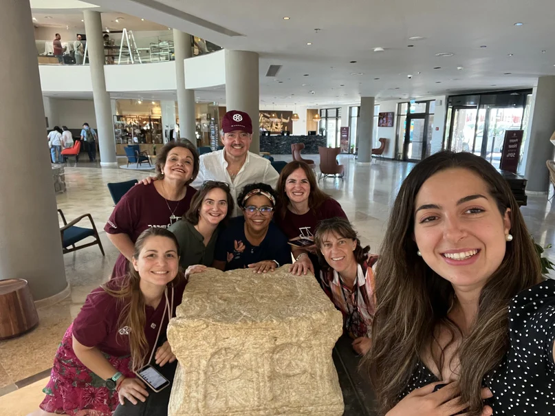 Mariana and friends gathered around a table in the Holy Land